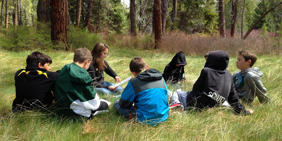 kids with teacher in field